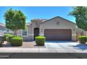 Charming single-story home with well-manicured landscaping, a two-car garage, and inviting curb appeal at 17851 N Mughetto Dr, Maricopa, AZ 85138