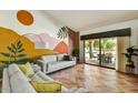 Bright living room showcasing a colorful mural wall, modern furniture, and natural light at 19025 N 96Th Ave, Peoria, AZ 85382