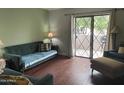 Cozy living room with hardwood floors and door to the outside patio at 1920 W Lindner Ave # 222, Mesa, AZ 85202