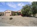 Charming desert home featuring low-maintenance landscaping and a covered front entrance at 19714 N Concord Dr, Surprise, AZ 85374