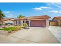 Single-story home featuring well-maintained lawn, driveway with basketball hoop, and inviting front entrance at 2009 W Calle Del Norte Dr, Chandler, AZ 85224