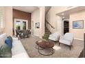 Open-concept living space with plush carpeting, stylish furniture, and abundant natural light at 22063 N 77Th St, Scottsdale, AZ 85255
