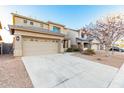 Two-story home with a two-car garage, desert landscaping, and neutral colored stucco at 22500 N Greenland Park Dr, Maricopa, AZ 85139