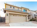 Two-story home with a two-car garage, desert landscaping, and neutral colored stucco at 22500 N Greenland Park Dr, Maricopa, AZ 85139