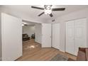 Bright room with hardwood floors and open doorway to cozy living area featuring convenient closet at 2301 E University Dr # 256, Mesa, AZ 85213