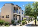 Attractive two-story home featuring a balcony, complemented by well-manicured landscaping and a sidewalk at 2363 W Dusty Wren Dr, Phoenix, AZ 85085