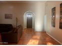 Spacious living room with tile flooring, comfortable seating, neutral colors, and a view of the entry at 25722 S 179Th St, Queen Creek, AZ 85142
