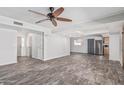 Bright and airy living room features new flooring, modern ceiling fan, and open floor plan at 3030 S Rogers --, Mesa, AZ 85202