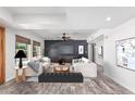 Bright living room featuring contemporary decor, a sleek entertainment center and comfortable seating at 3030 S Rogers --, Mesa, AZ 85202