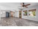 Spacious living room showcasing new flooring, a modern ceiling fan, and natural light at 3030 S Rogers --, Mesa, AZ 85202