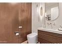 Stylish half bathroom featuring a modern vanity, sleek fixtures, and sophisticated lighting at 3128 E Tina Dr, Phoenix, AZ 85050