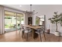 Elegant dining room with modern chandelier, large mirror, and sliding glass doors to the patio at 3128 E Tina Dr, Phoenix, AZ 85050