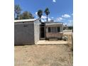 View of exterior including a covered patio area and palm trees in the background at 318 N 83Rd Pl, Mesa, AZ 85207