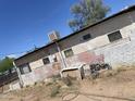 Exterior of house showing siding and roof with multiple windows and an air conditioner unit at 318 N 83Rd Pl, Mesa, AZ 85207