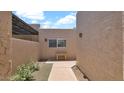 View of a home featuring a bench in an exterior courtyard with desert landscaping at 3345 E University Dr # 47, Mesa, AZ 85213