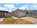 Charming home featuring a private gate, attached garage, and well-maintained front yard at 3345 E University Dr # 47, Mesa, AZ 85213