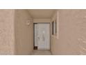 Up close view of a tan stucco entryway featuring a security door and window at 3345 E University Dr # 47, Mesa, AZ 85213