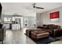 Open-concept living room with an island view, modern appliances, and lots of natural light at 3759 E Charter Oak Rd, Phoenix, AZ 85032