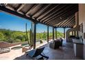 Outdoor patio features an outdoor kitchen, lounge seating, jacuzzi, dipping pool, and views of the desert landscape at 41503 N 109Th Pl, Scottsdale, AZ 85262