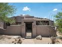 Beautiful exterior showcasing a private entrance with an iron gate and a meticulously maintained desert landscape at 41503 N 109Th Pl, Scottsdale, AZ 85262
