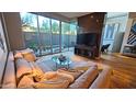 Bright living room featuring plush sofa, glass coffee table, floor-to-ceiling windows, and stylish decor at 5455 E Lincoln Dr # 1004, Paradise Valley, AZ 85253