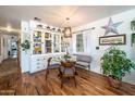 Cozy dining room with a glass table, built-in display cabinet, and hardwood floors at 632 S 83Rd Way, Mesa, AZ 85208