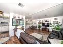 Spacious living room featuring hardwood floors and seamless access to the kitchen and dining area at 632 S 83Rd Way, Mesa, AZ 85208