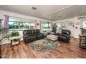 Inviting living room featuring hardwood floors, multiple windows, and comfortable seating at 632 S 83Rd Way, Mesa, AZ 85208