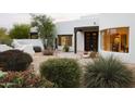 Charming Santa Fe home featuring a large picture window, custom wood accents, and professionally landscaped yard at 8601 E De La O Rd, Scottsdale, AZ 85255