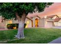 Attractive single-Gathering home featuring beautiful landscaping, a tile roof, and a two-car garage at 8875 S Ash Ave, Tempe, AZ 85284