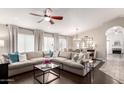 Bright living room featuring hardwood floors, a large sofa, and natural light from large windows at 8875 S Ash Ave, Tempe, AZ 85284