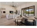 Stylish dining area adjacent to the living room, featuring modern furnishings and ample natural light at 9820 N 87Th Pl, Scottsdale, AZ 85258