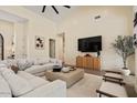 A bright, neutral living room with high ceilings, large sectional sofa and stylish decor at 9820 N 87Th Pl, Scottsdale, AZ 85258