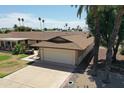 Inviting single-story home with a two-car garage and a well-maintained lawn at 10236 N 105Th Dr, Sun City, AZ 85351