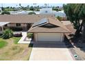 Charming single-story home with a two-car garage and solar panels on the roof in a quiet neighborhood at 10236 N 105Th Dr, Sun City, AZ 85351