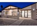 Inviting entrance features a cozy seating area, modern architectural details, and beautiful paving stones at 11007 N 26Th St, Phoenix, AZ 85028