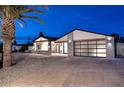 Stunning home exterior featuring a modern design, xeriscaping, brick accents and a contemporary glass panel garage door at 11007 N 26Th St, Phoenix, AZ 85028