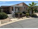 Inviting single-story home with a cozy front porch and well-manicured landscaping at 11411 N 91St Ave # 229, Peoria, AZ 85345