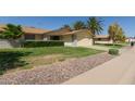 Beautiful single-story home featuring desert landscaping and a well-manicured lawn at 12711 W Omega Dr, Sun City West, AZ 85375
