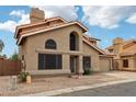 Two-story home featuring a tile roof, neutral stucco, and a two-car garage at 1344 N Brittany Ln, Gilbert, AZ 85233