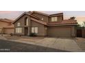 Home exterior at dusk showcasing architectural details and a tile roof at 1344 N Brittany Ln, Gilbert, AZ 85233