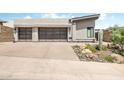 Contemporary home featuring desert landscaping and two-car garage with glass panel doors at 14507 N Valencia Dr, Fountain Hills, AZ 85268