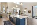 Spacious kitchen with a large island, stainless steel appliances, and modern pendant lighting at 14507 N Valencia Dr, Fountain Hills, AZ 85268