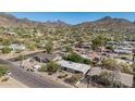 Scenic aerial view showcasing the neighborhood with stunning mountain views and lush greenery, providing a serene setting at 1541 E Cinnabar Ave, Phoenix, AZ 85020