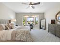 Serene main bedroom with large bay windows offering plentiful natural light and neutral tones throughout at 15502 W Agua Linda Ln, Surprise, AZ 85374