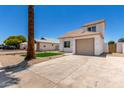 Exterior view of home featuring fresh exterior paint, low maintenance desert landscaping, and attached garage at 1605 W Curry Dr, Chandler, AZ 85224