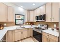 This modern kitchen boasts stainless steel appliances, bright countertops and light wood cabinets at 17349 E Quail Ridge Dr, Fountain Hills, AZ 85268