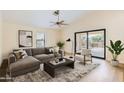 Bright living room featuring a comfortable sectional sofa and sliding glass doors to the outdoor space at 17349 E Quail Ridge Dr, Fountain Hills, AZ 85268