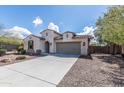 A single story home with a two car garage, desert landscaping, and a walkway to the front door at 18149 W Turney Ave, Goodyear, AZ 85395