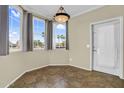 Charming dining nook featuring tiled floors, decorative lighting, and bright windows with neighborhood views at 1941 S Pierpont Dr # 1014, Mesa, AZ 85206